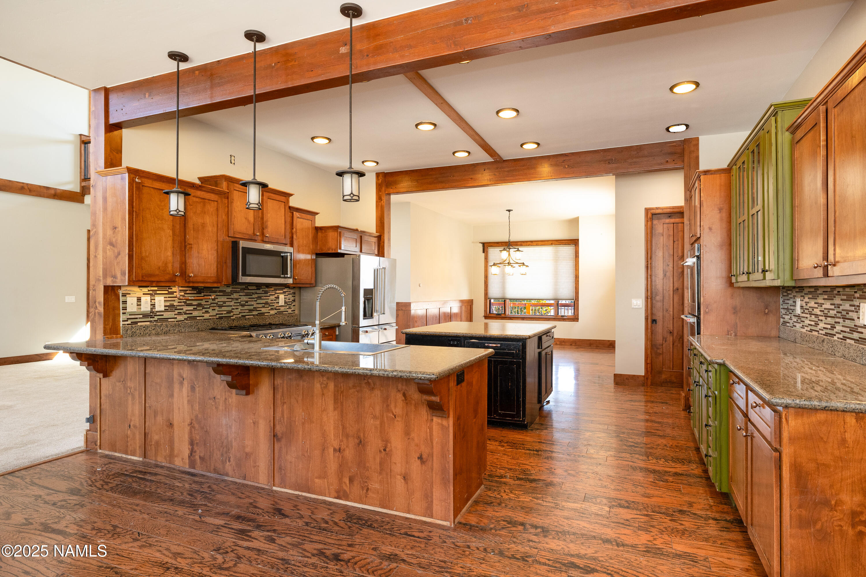 5835 Switchback Trail Flagstaff, AZ 86004 - Photo 7 of 35 a kitchen with lots of counter top space and wooden floor