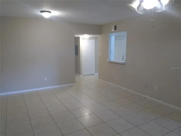 an empty room with windows and entrance