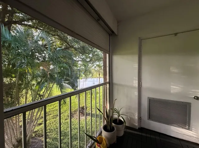 a view of a porch with furniture and garden
