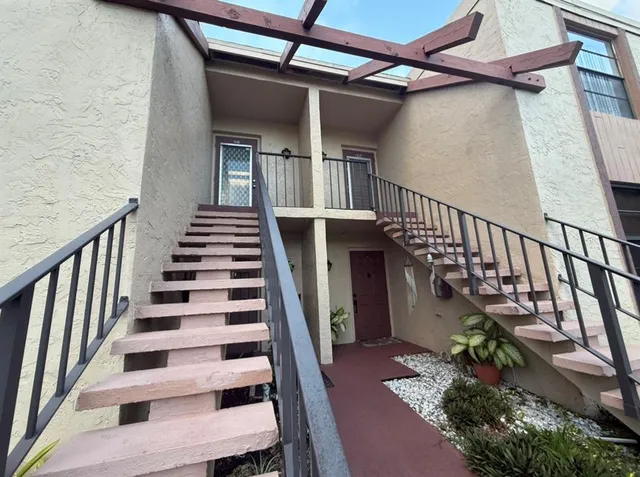 a view of entryway with wooden floor and stairs