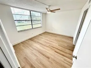 an empty room with windows and closet