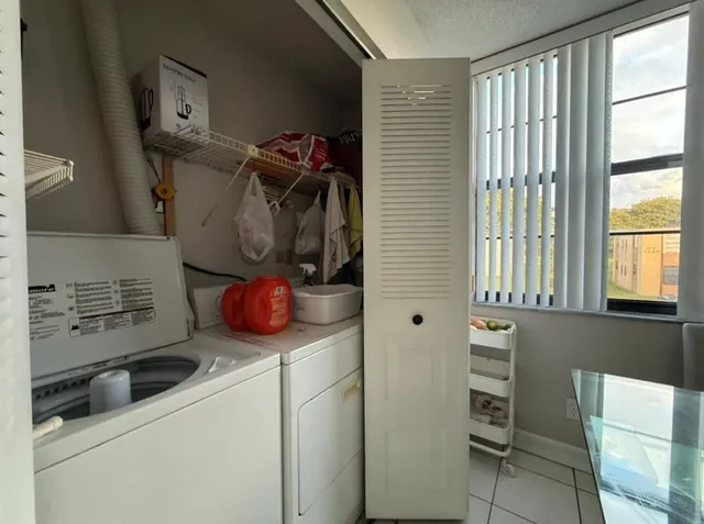 a bathroom with a washing machine and sink
