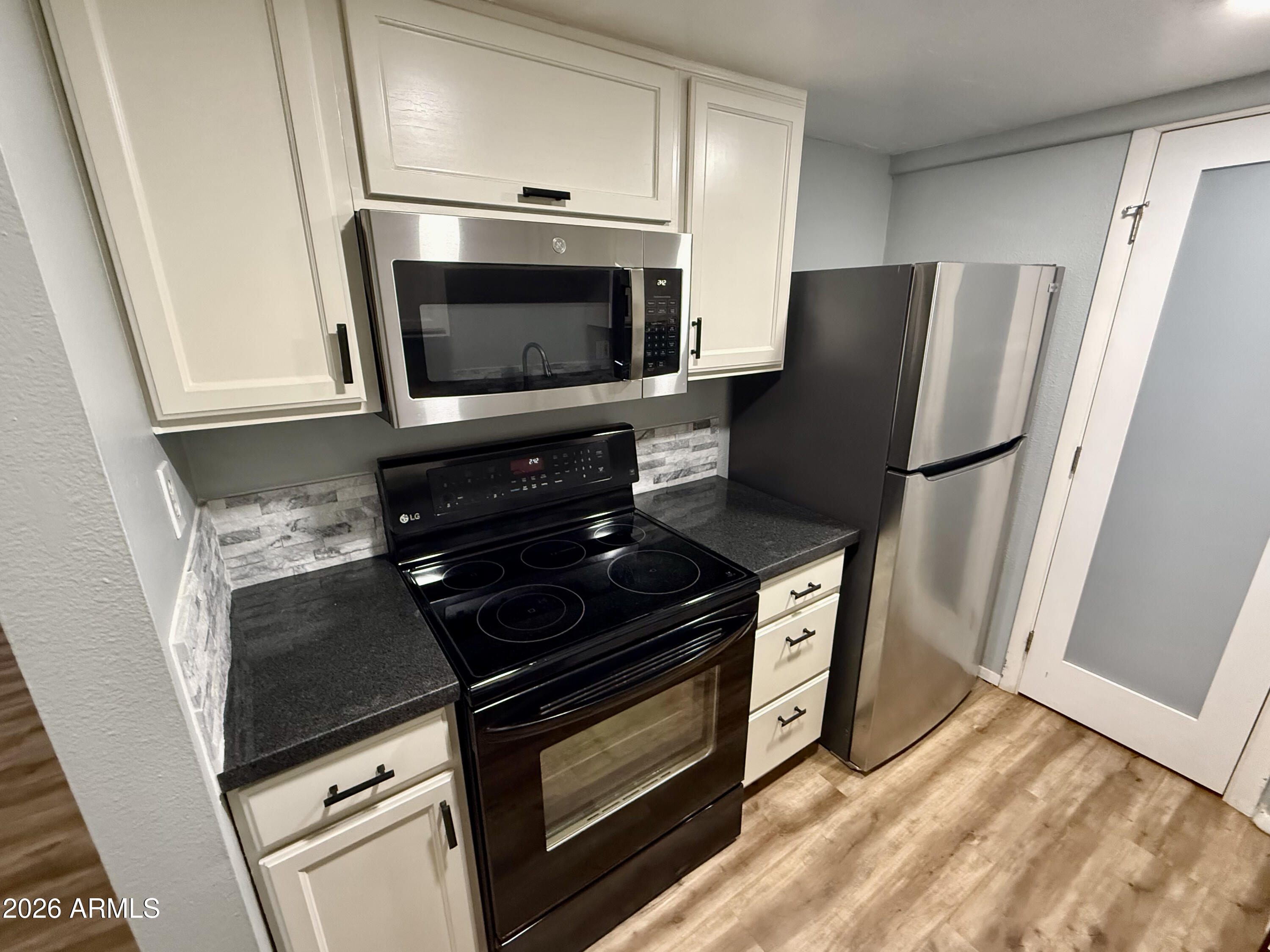 600 South Dobson Road, Unit 111 Mesa, AZ 85202 - Photo 1 of 24 a kitchen with a stove and a microwave