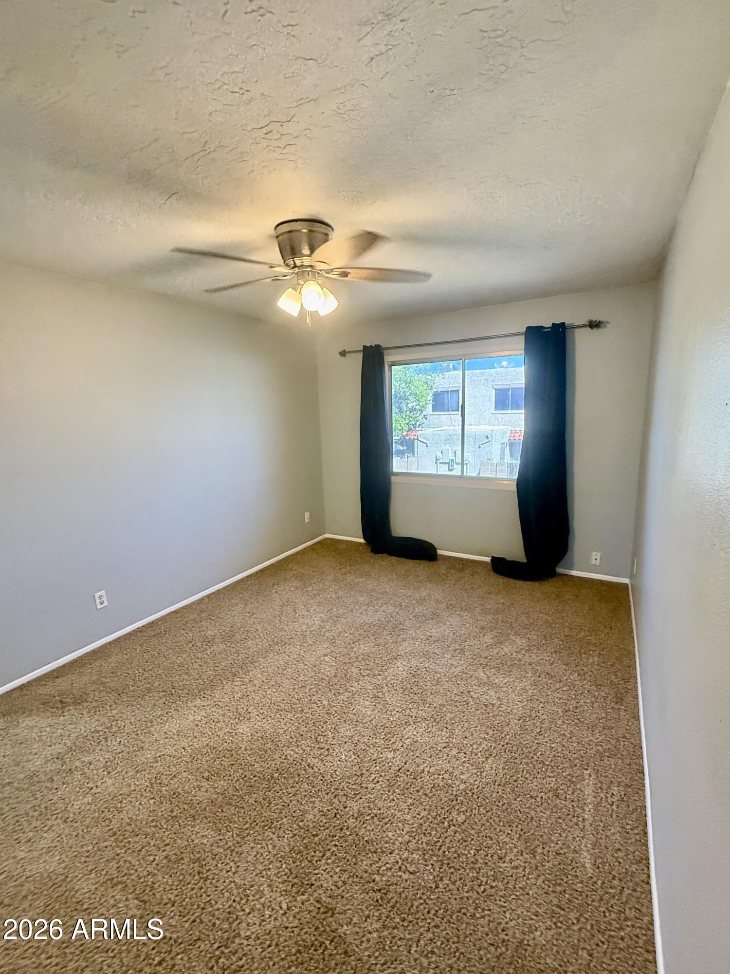 600 South Dobson Road, Unit 111 Mesa, AZ 85202 - Photo 15 of 24 an empty room with windows and fan