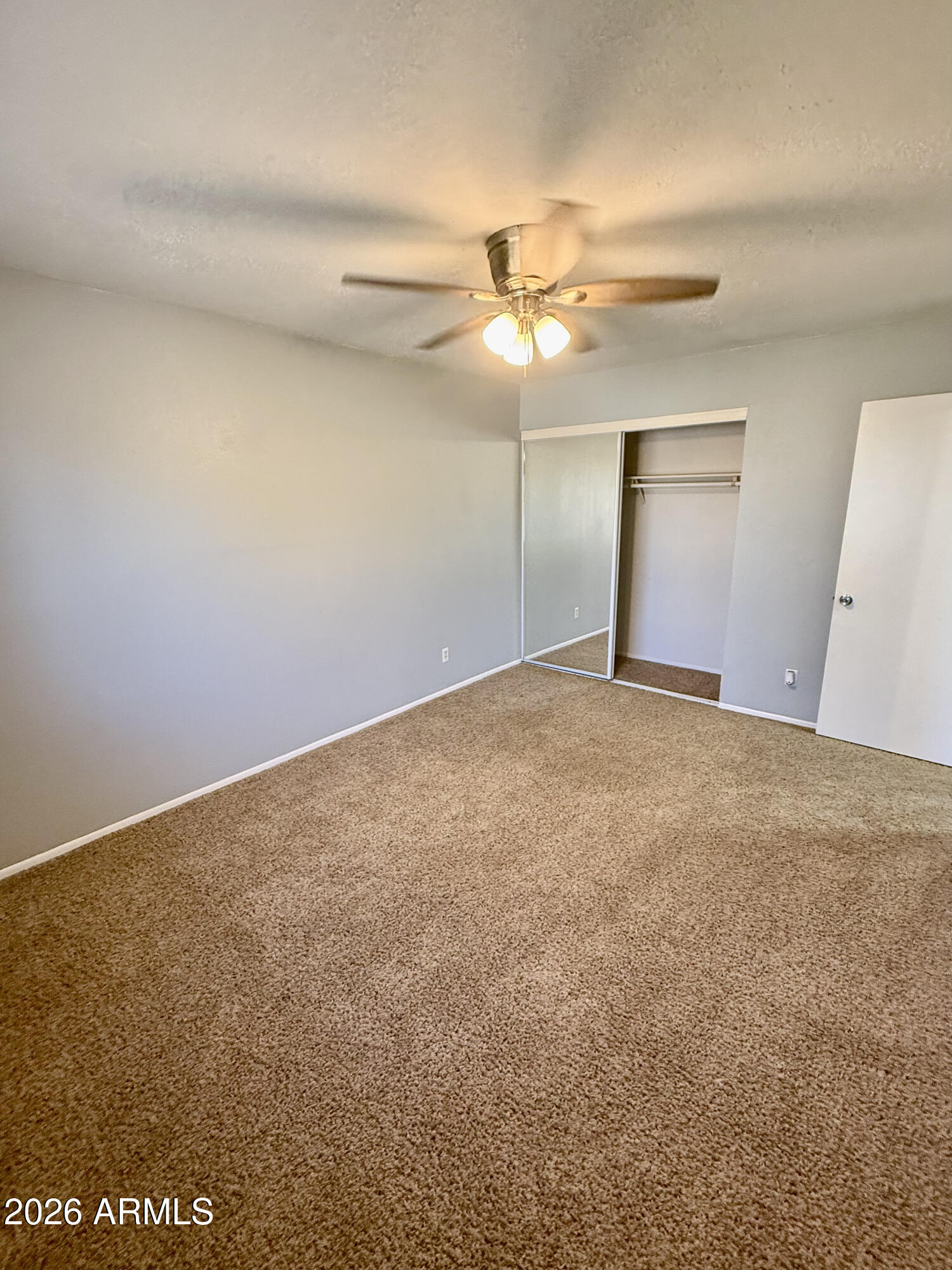 600 South Dobson Road, Unit 111 Mesa, AZ 85202 - Photo 16 of 24 an empty room with a fan and a fan