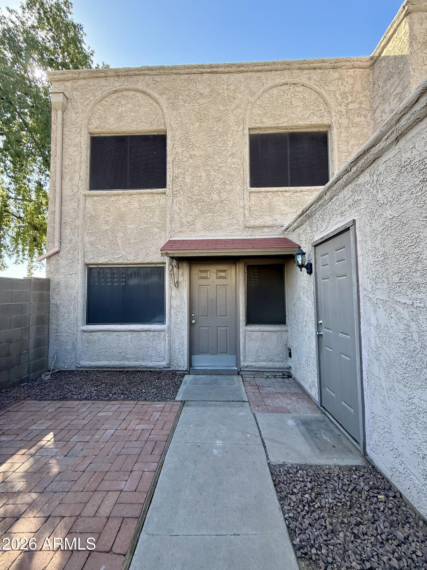 600 South Dobson Road, Unit 111 Mesa, AZ 85202 - Photo 24 of 24 a view of a house with a door and a yard