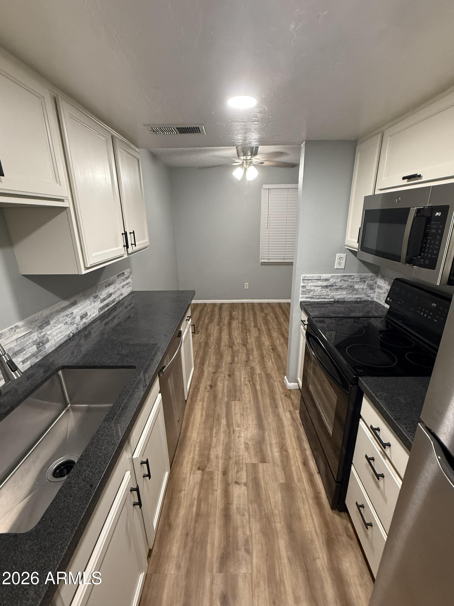 600 South Dobson Road, Unit 111 Mesa, AZ 85202 - Photo 3 of 24 a kitchen that has a sink and a stove