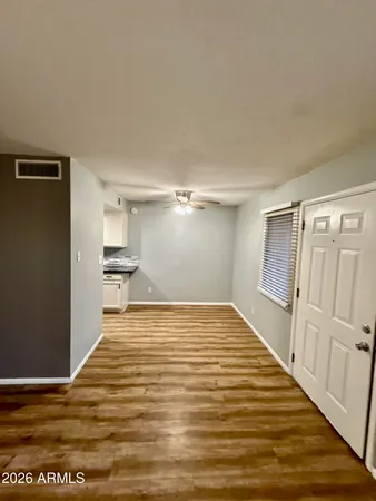 a view of empty room with wooden floor