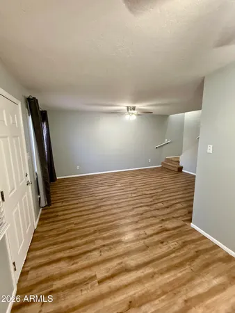 a view of a room with wooden floor