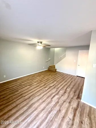 a view of empty room with wooden floor