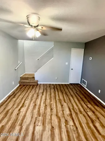 a view of a room with wooden floor