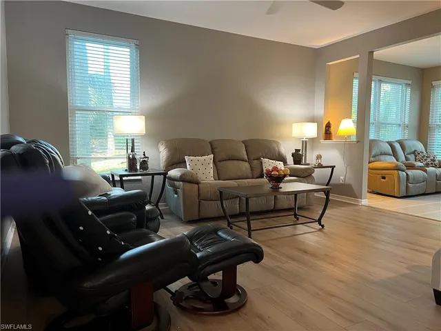 a living room with furniture and wooden floor