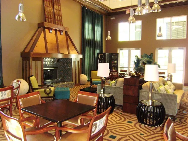 a living room with furniture a window and a chandelier