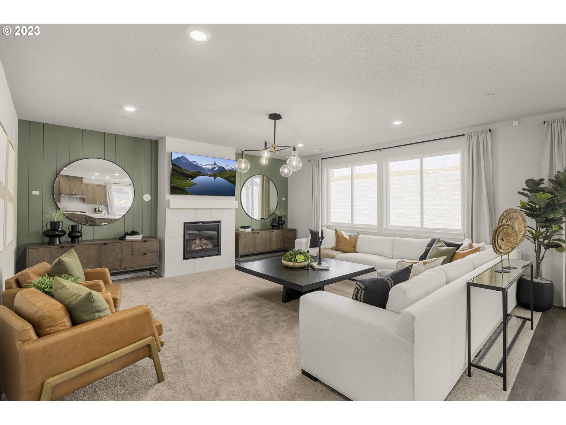 2705 South 7th Circle Ridgefield, WA 98642 - Photo 12 of 33 a living room with furniture a fireplace and a chandelier