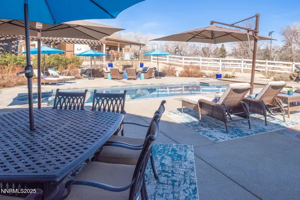 an outdoor space with seating pool and furniture