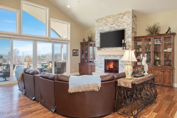 a living room with fireplace furniture and a flat screen tv