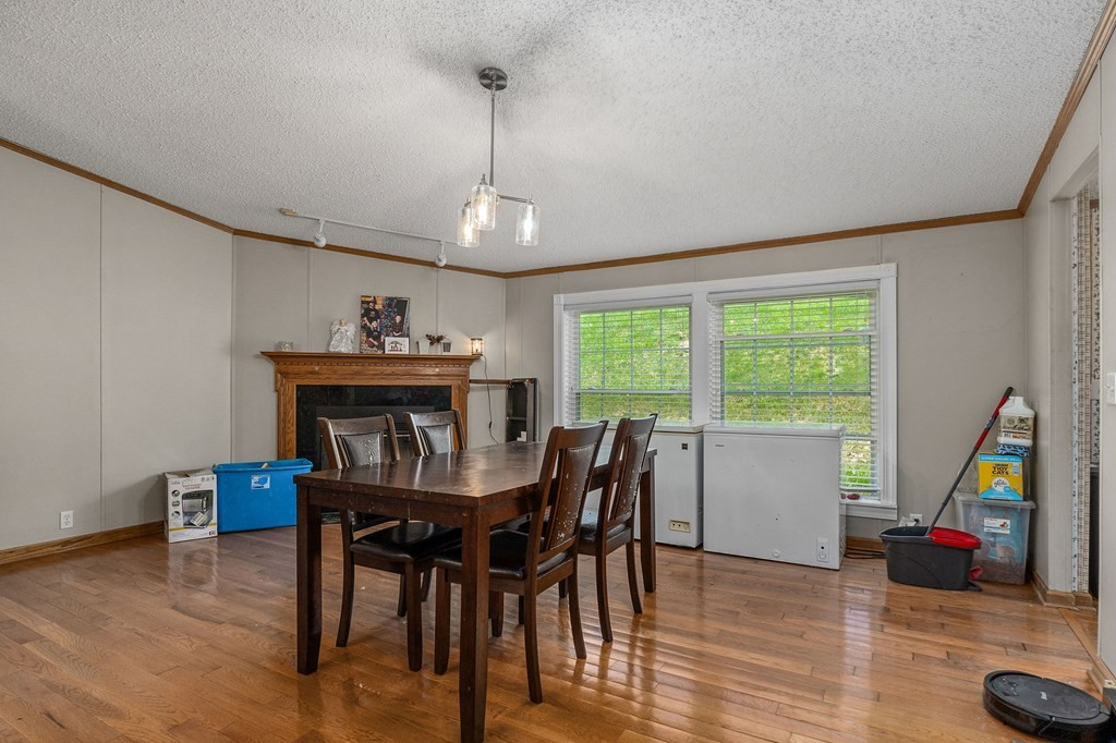 431 Mohawk Valley Road Monroe, TN 38573 - Photo 11 of 28 a view of a dining room with furniture a chandelier and wooden floor