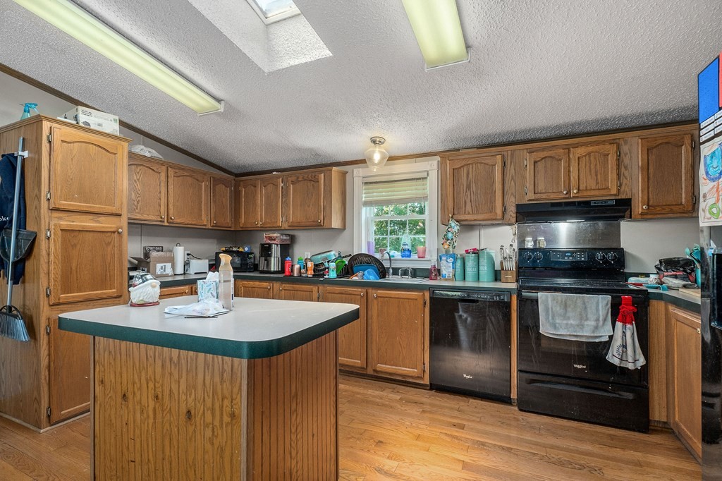 431 Mohawk Valley Road Monroe, TN 38573 - Photo 14 of 28 a kitchen with stainless steel appliances granite countertop a sink stove refrigerator and cabinets
