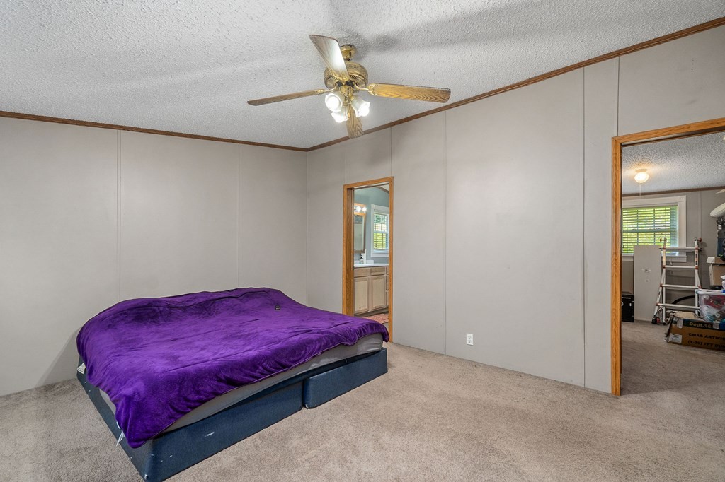 431 Mohawk Valley Road Monroe, TN 38573 - Photo 18 of 28 a bedroom with a bed and a chandelier
