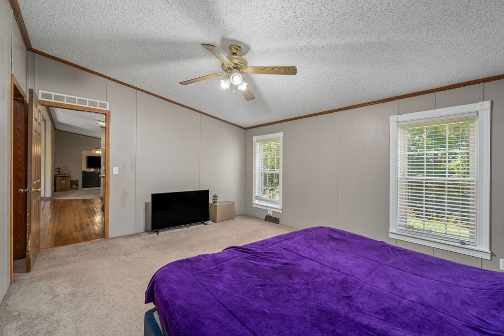 431 Mohawk Valley Road Monroe, TN 38573 - Photo 20 of 28 a bedroom with a bed and a chandelier