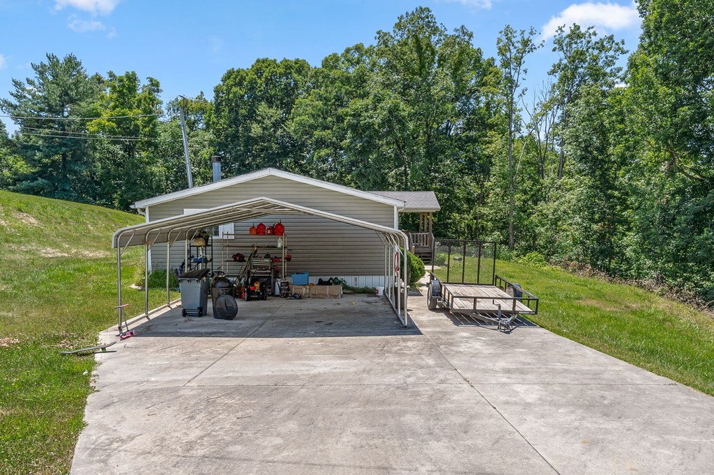 431 Mohawk Valley Road Monroe, TN 38573 - Photo 4 of 28 a view of a patio with table and chairs potted plants and a big yard