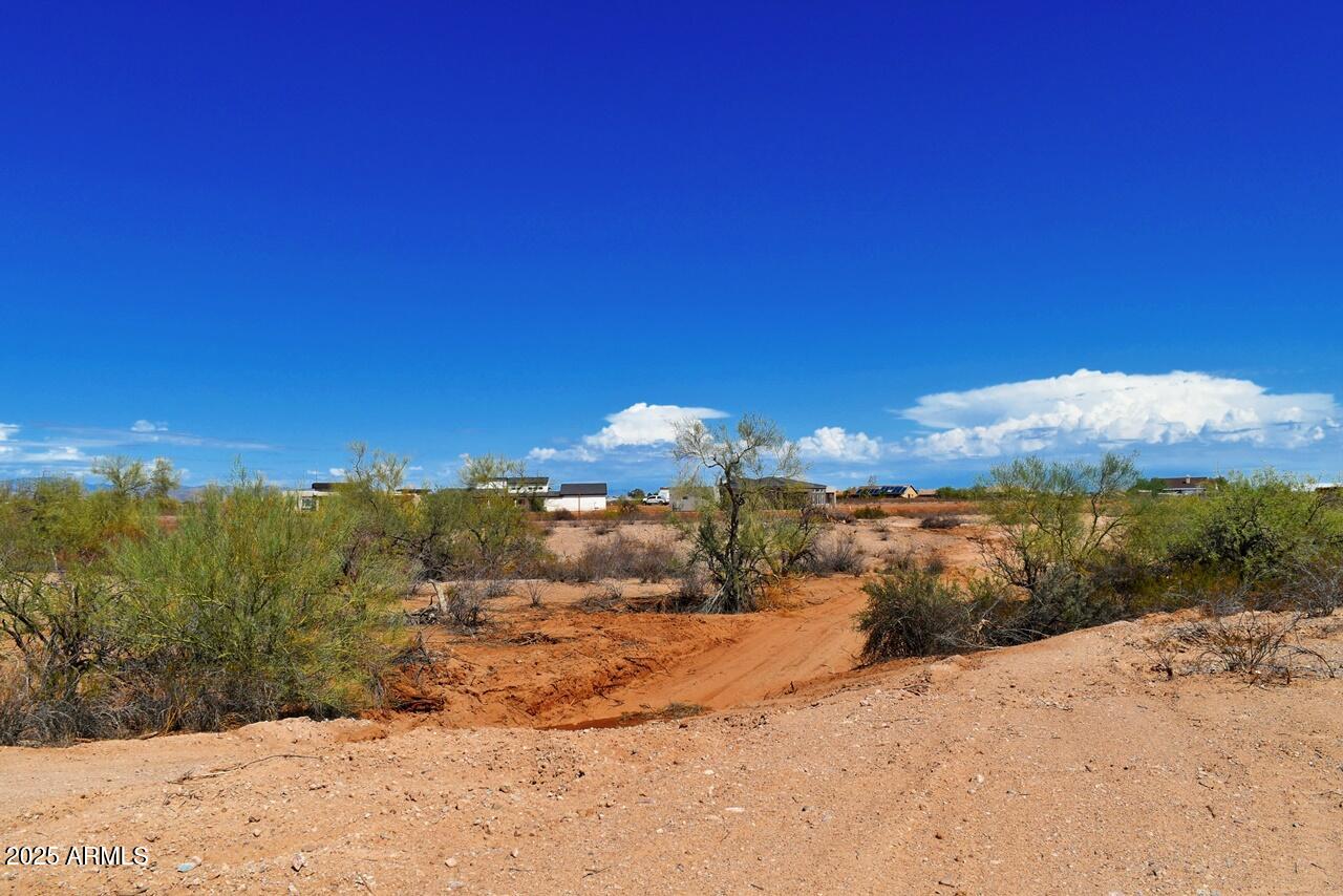 2334 West Montgomery Road, Unit 3 Wittmann, AZ 85361 - Photo 8 of 13 a view of a yard next to a building