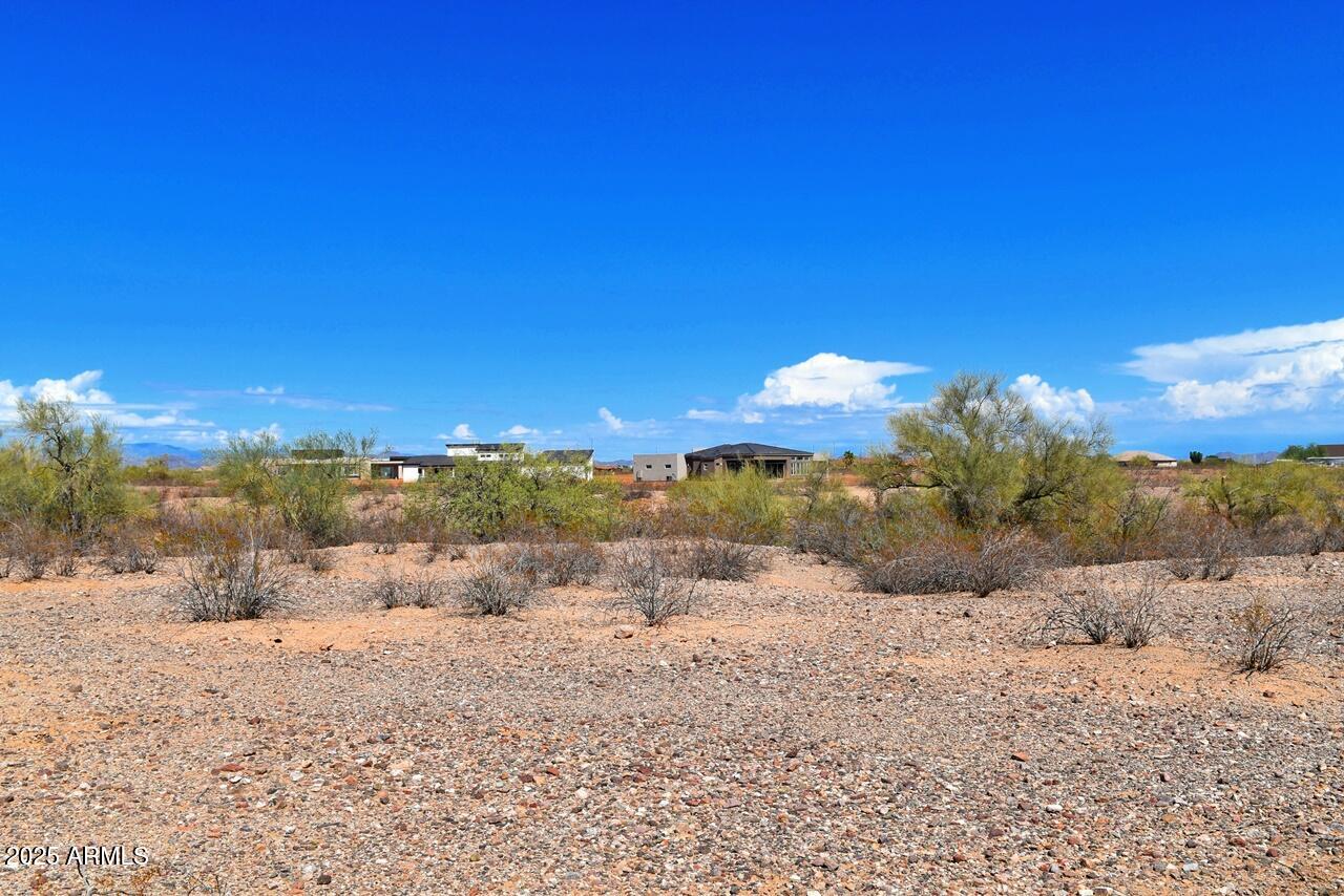 2334 West Montgomery Road, Unit 3 Wittmann, AZ 85361 - Photo 10 of 13 a view of a road with a building in the background