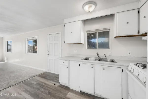 a kitchen with sink cabinets and stove