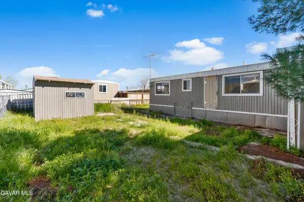 a view of a house with a backyard and a garden