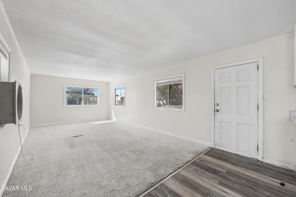 an empty room with windows and closet