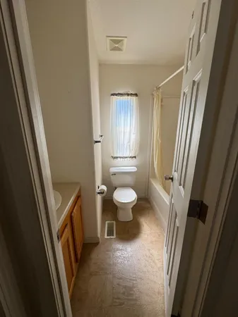 a bathroom with a sink a toilet a tub and a shower