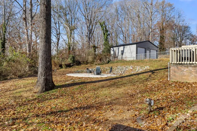 a view of a backyard with wooden fence