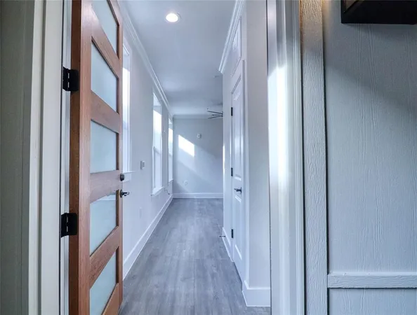 a view of gallery with wooden floor