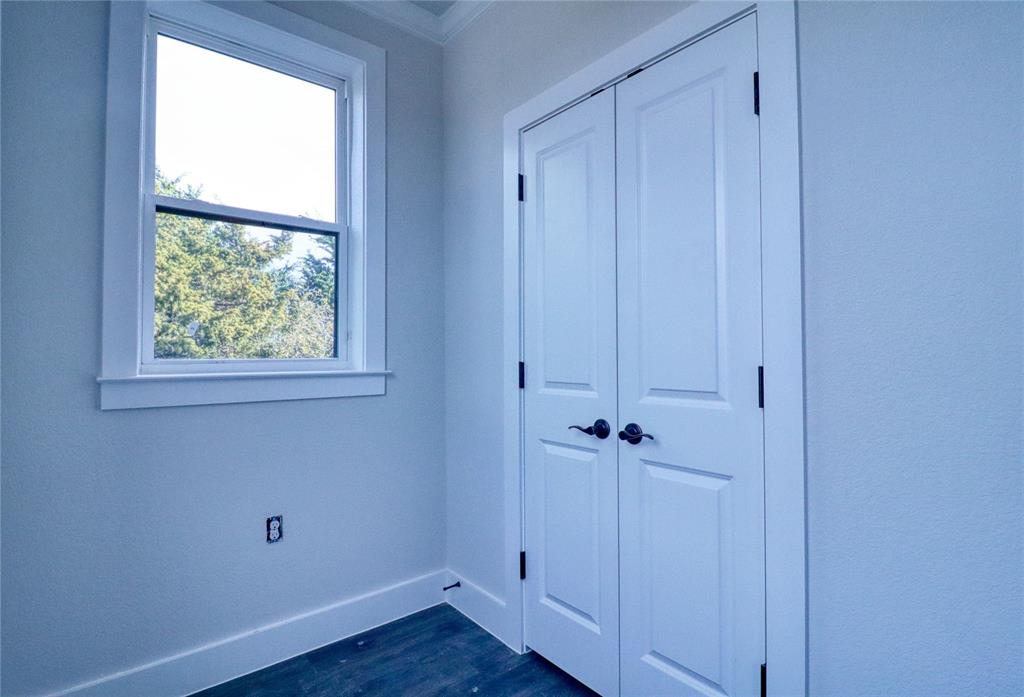 525 George Hopper Road, Unit 210 Midlothian, TX 76065 - Photo 14 of 20 an empty room with wooden floor and a window