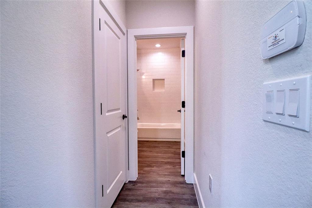 525 George Hopper Road, Unit 210 Midlothian, TX 76065 - Photo 16 of 20 a view of a bathroom from a hallway
