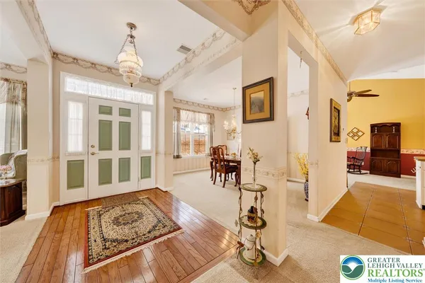 a view of a livingroom with furniture wooden floor and windows