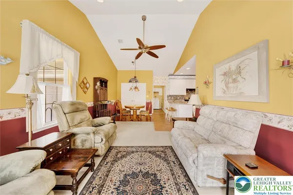 a living room with furniture a couch and a chandelier