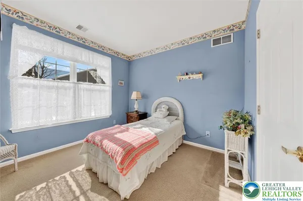a bedroom with bed and a window