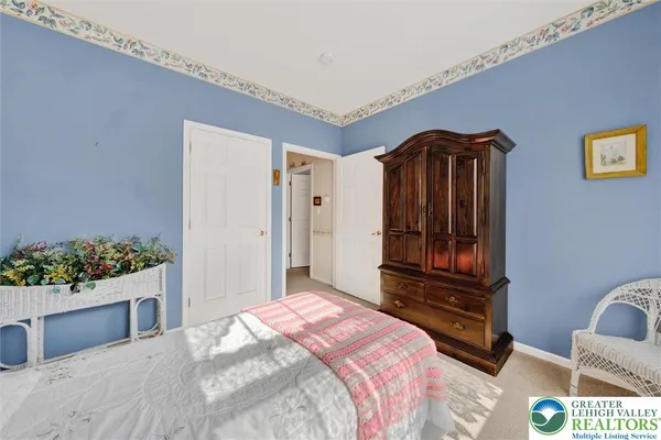 a bedroom with a bed dresser and a window