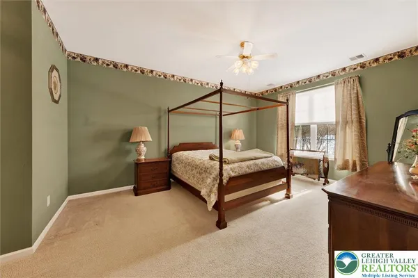 a bedroom with a bed lamp and a window