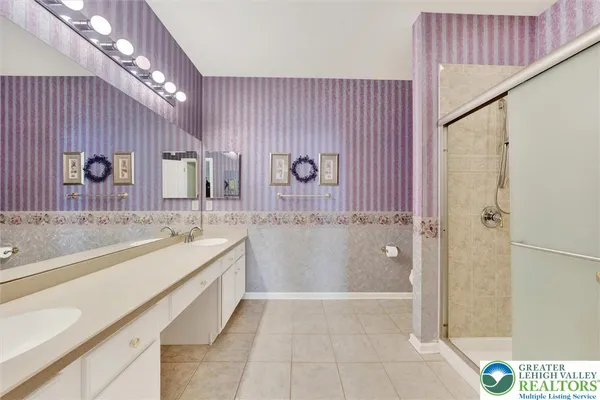 a spacious bathroom with a tub a sink and mirrors