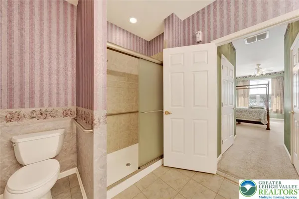 a bathroom with a toilet a sink and a shower