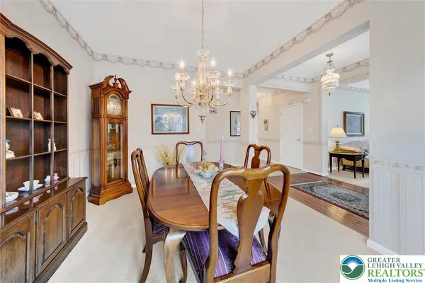 a view of a dining room with furniture and chandelier