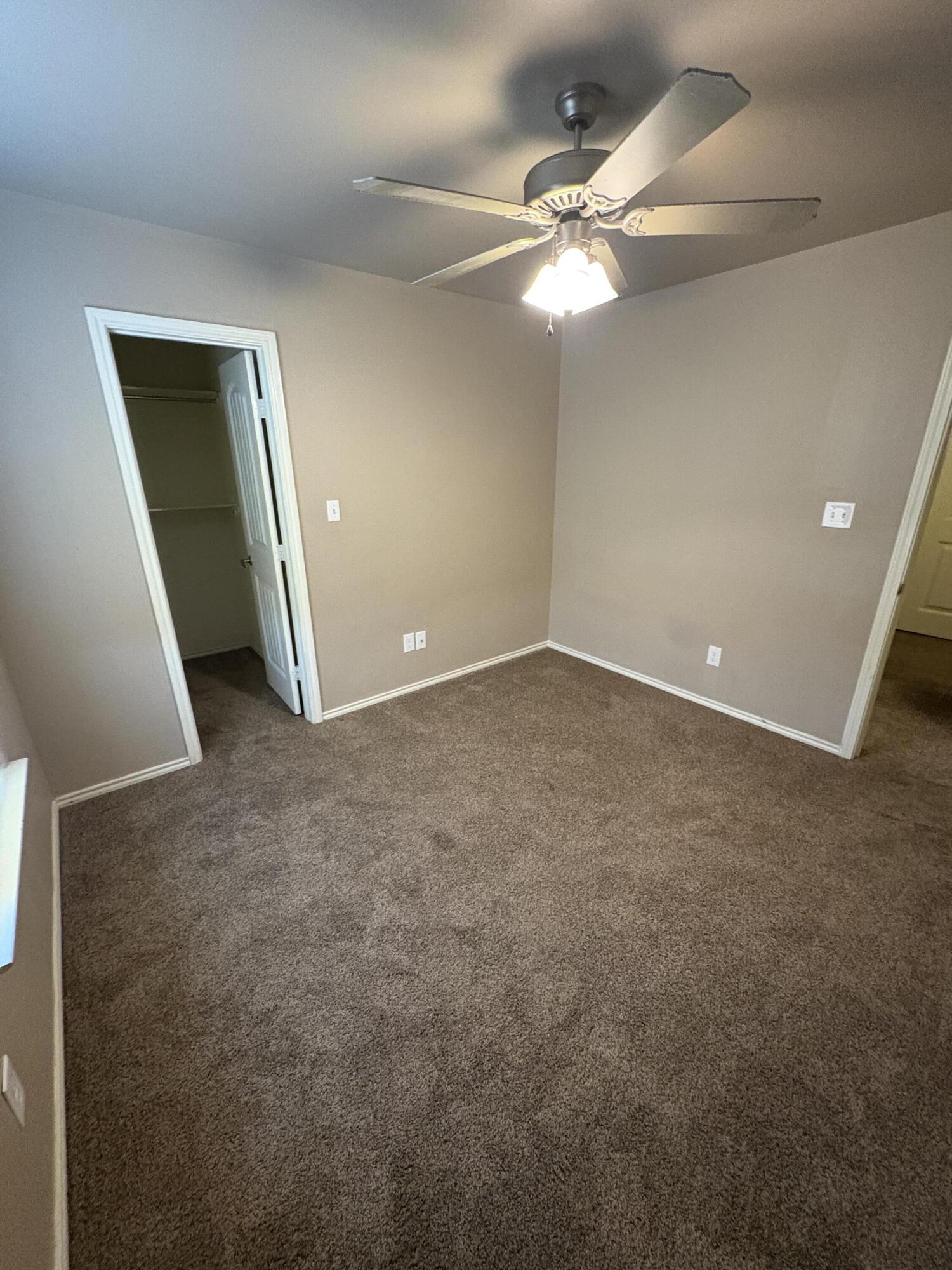 1236 Wheelock Street Lubbock, TX 79403 - Photo 11 of 17 a view of an empty room with a chandelier fan