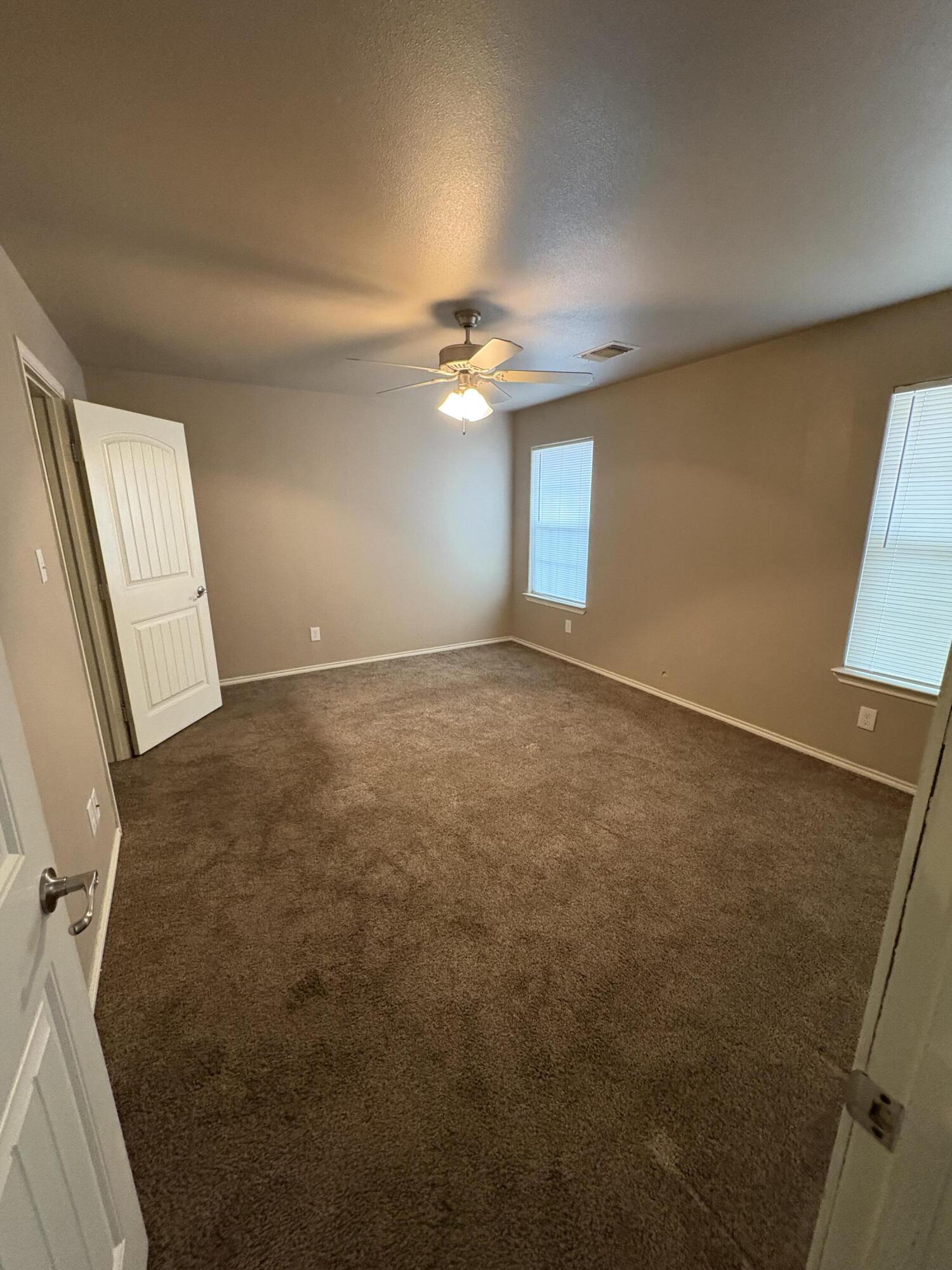 1236 Wheelock Street Lubbock, TX 79403 - Photo 6 of 17 an empty room with windows and fan