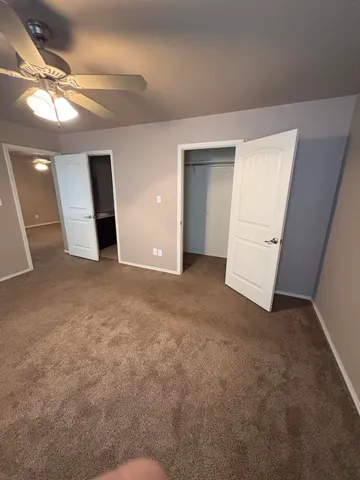 en empty room with windows and bathroom view