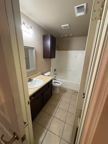 a bathroom with a sink a toilet a mirror and vanity
