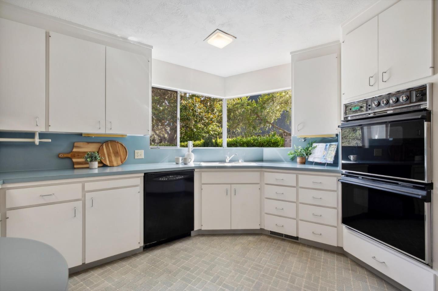 1109 Arroyo Drive Pebble Beach, CA 93953 - Photo 17 of 43 a kitchen with granite countertop a stove sink and microwave