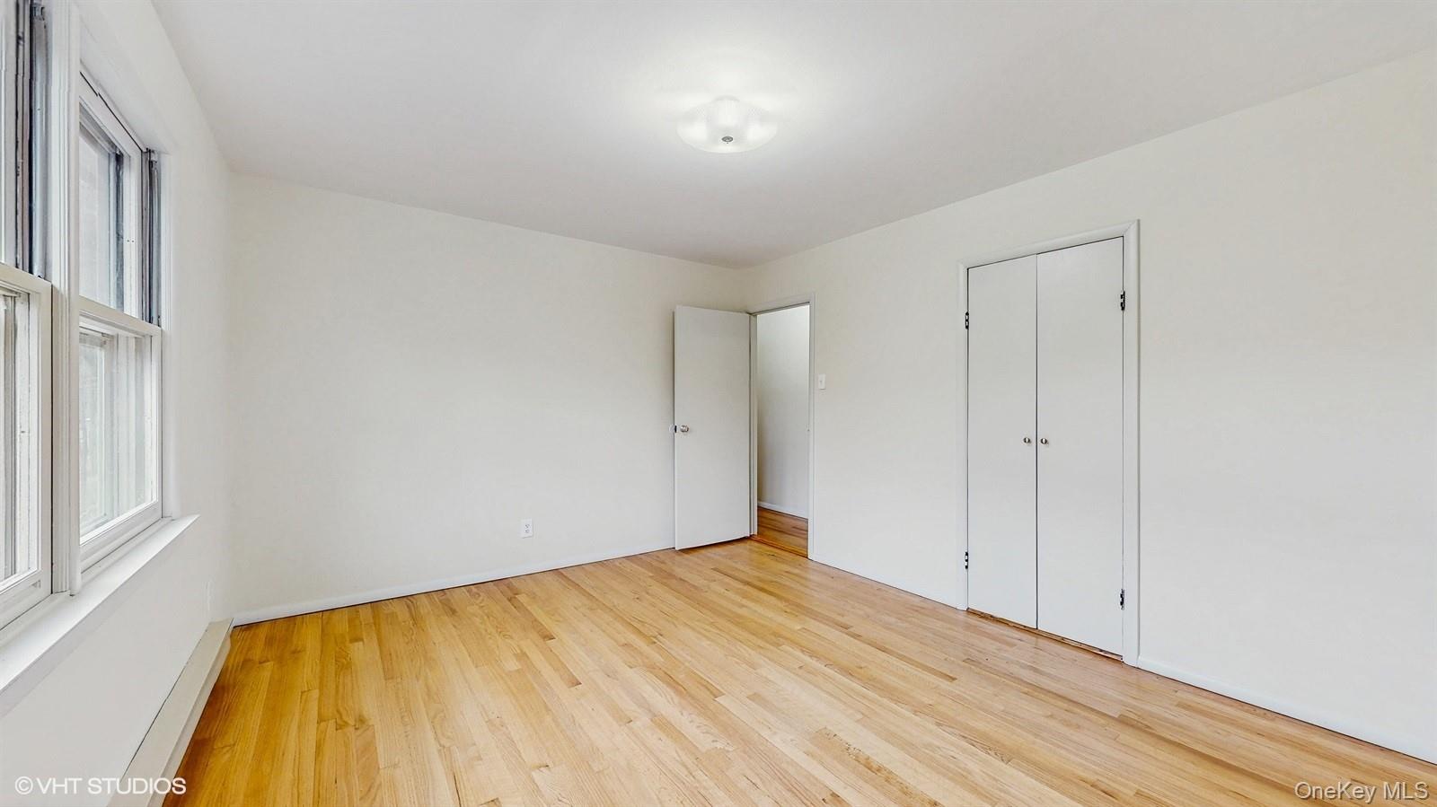 736 State Rte 55 Napanoch, NY 12458 - Photo 11 of 49 Primary bedroom with multiple windows wood finished floors
