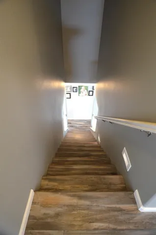 a view of a hallway view with wooden floor and staircase